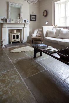 a living room filled with furniture and a fire place