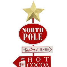 a street sign with the words north pole, santa's workshop and hot cocoa written on it