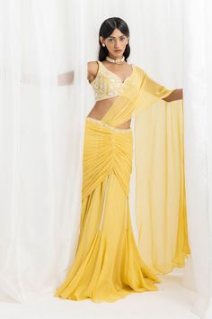 Editor's Note A yellow embellished choli paired with an embellished pre-stitched flared sari and blouse would make for a stunning outfit. You can accessorize with statement jewelry and a clutch to complete the look. Fabric: Blouse: georgette, sari: georgette and organza, lining: satin Color: Yellow Components: Sari and blouse Occasion: Cocktail, haldi mehndi and Wedding Guest Disclaimer: Product color may slightly vary due to photographic lighting sources or your monitor setting. Care: Dry clean Blouse Yoke, Haldi Outfit, Yellow Embroidery, Personal Shopping Service, Embroidery Saree, Stunning Outfits, Satin Color, Traditional Sarees, Photographic Lighting