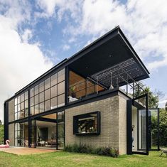 a modern house with large windows on the roof