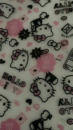 a bunch of hello kitty stickers on a white surface with pink and black designs