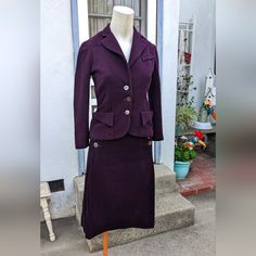 Vintage 1940s Plum Doeskin Skirt And Jacket Suit Set. Note, Velvety Doeskin Does Pick Up Pet Hair And Lint Extremely Quickly, Carry A Lint Roller With This One! Mother Of Pearl Buttons, Pink Satin-Like Lining. Good Vintage Condition, Jacket Is Missing Top Button But There Is An Extra Sewn Inside. Lining Is Worn And Discolored (See Photos). Skirt: 27" Waist (Buttons Can Be Moved To Make Bigger) 25" Length Jacket: 16 1/2" Underarm To Underarm Laid Flat. 15" Waist Laid Flat (Double). 21" From High Point Shoulder To Sleeve Cuff. Plum Suit, Skirt And Jacket, Jacket Suit, Lint Roller, Sleeve Cuff, Suit Set, Mother Of Pearl Buttons, Pearl Buttons, High Point