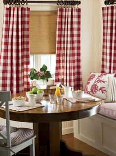 a dining room with red and white checkered curtains