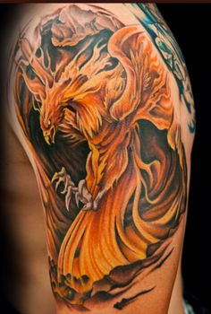 a man's arm with an orange and black dragon tattoo on the left side