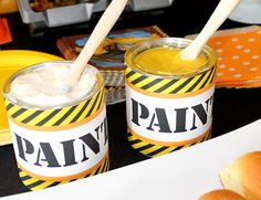 two jars filled with food sitting on top of a table