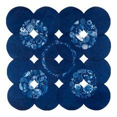 six circular blue coasters with flowers on them