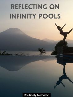 a woman standing on top of a pool next to a large body of water with the words reflecting on infinity pools