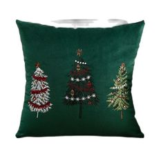 three christmas trees on green velvet pillow