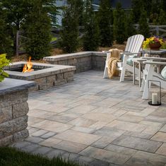 an outdoor patio with chairs and fire pit