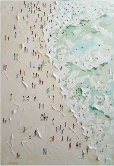 an aerial view of people walking on the beach