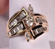 14k Marquise Baguette 1.65ct t.w. Diamond Ring Yellow Gold Condition: Pre-Owned. Statement diamond ring in solid 14k yellow gold. 1.65 ct T.W. diamonds. 3 Marquise diamonds: .40 center is VS1, I-J. 2 smaller marquise total .50ct, SI clarity, I/J color. Baguettes total .75 ct, VS/SI clarity G/H color. Total carat weight is 1.65! Finger size 8 1/2. Ring weighs 9.1 grams. Newly polished - Looks Great!   Item ID: 56323 We combine shipping for multiple item purchases - MUST BE PAID TOGETHER! PLEASE - Bid and buy at your leisure for combined shipping - we request you pay combined items within 10 days of first item won. We are unable to honor requests for combined shipping discounts if items have been paid separately. eBay does show our combined shipping on the shipping tab.  If you're purchasing Polished Look, G H, 10 Days, Jewelry Rings, Fine Jewelry