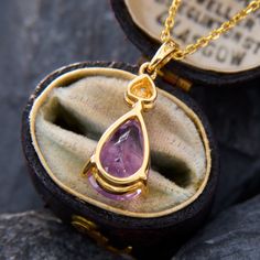 This very pretty pendant necklace features a pear cut amethyst and three single cut diamonds accenting above it. The pendant measures 19.3mm long by 9.2mm wide. The piece is crafted in 14k yellow gold and comes with a 14k yellow gold 18 inch cable chain with jump rings so it can also be worn at 16 and 17 inches long. Yellow Gold Pear-shaped Amethyst Jewelry, Pear-shaped Amethyst Jewelry In Yellow Gold, Pear-shaped Amethyst Jewelry As Gift, Teardrop Amethyst Necklace For Formal Occasions, Formal Teardrop Amethyst Necklace, Pear-shaped Amethyst Necklace As A Gift, Gift Pear-shaped Amethyst Necklaces, Pear-shaped Amethyst Necklace For Gift, Gift Pear-shaped Amethyst Necklace