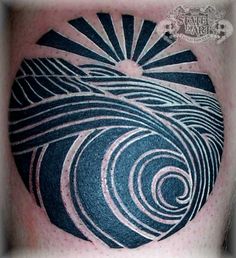 a man with a tattoo on his arm that has an image of a sun and waves