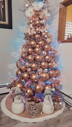 a christmas tree decorated with gold and silver ornaments