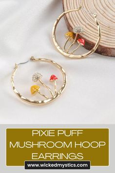 Add a sprinkle of fairy-tale charm to your everyday look with the Pixie Puff Mushroom Hoop Earrings. These enchanting earrings feature dainty mushroom charms crafted in a warm gold tone, suspended from sleek and stylish hoops. #PixiePuffEarrings #MushroomJewelry #HoopEarrings #FairyFashion #NatureInspired #WhimsicalStyle #CuteAccessories #FantasyJewelry Kawaii Mushroom, Cottagecore Earrings, Hammered Jewelry, Mushroom Jewelry, Mushroom Earrings, Nature Earrings, Ear Stud, Big Earrings, Earring Jewelry