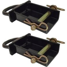 two black trays with gold handles holding scissors