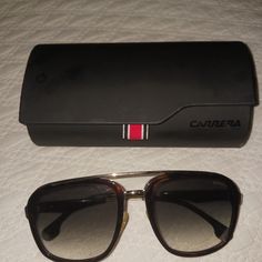 These Sleek And Stylish Carrera 133/S Sunglasses Are A Must-Have For Any Fashionable Man. With A Bold Black Frame And A Classic Design, These Sunglasses Are Perfect For Any Occasion. Crafted By The Renowned Brand Carrera, These Sunglasses Are Sure To Impress. The High-Quality Construction And Attention To Detail Make Them A Reliable And Durable Accessory. Whether You're Heading To The Beach Or Out On The Town, These Sunglasses Are The Perfect Choice. Designer Aviator Sunglasses With Tinted Lenses, Designer Business Sunglasses With Tinted Lenses, Luxury Business Sunglasses With Tinted Lenses, Casual Sunglasses With Gradient Lenses For Business, Trendy Business Sunglasses With Gradient Lenses, Casual Business Sunglasses With Gradient Lenses, Trendy Sunglasses With Gradient Lenses, Carrera Sunglasses, Black Cat Eyes