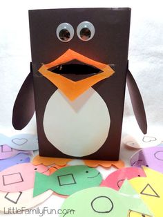 a penguin made out of construction paper with eyes