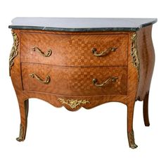 an ornate wooden dresser with marble top