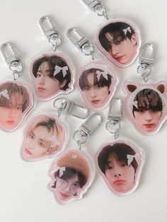 six keychains with the faces of bts members in different styles and colors