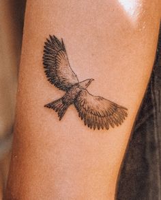 a small bird tattoo on the leg