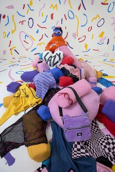 a pile of stuffed animals sitting on top of a white floor covered in confetti