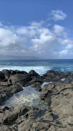 the rocks are covered with water and clouds in the distance, while there is no image here to provide a caption for