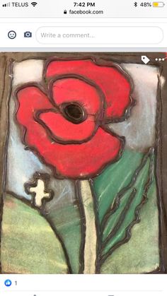 an image of a stained glass window with a red flower