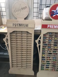 two wooden vending machines sitting next to each other on top of a counter in a store