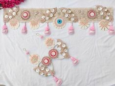 a white table topped with lots of pink and gold decorations on top of a table