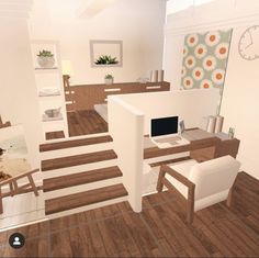 a computer desk sitting on top of a hard wood floor next to a white chair