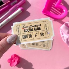 someone is holding up a ticket for their social club event on valentine's day