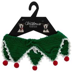 a green and white dog collar with red pom poms