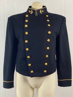 "Rare vintage 1960s U.S. Navy Women's Bolero jacket. Made of black wool. Features: a double breasted button front, brass U. S. Navy buttons and brass anchors at the neck. Has darts cut at the bust. Black rayon lining. Tailored for the United States Naval Academy by Jacob Reed's Sons. About a size medium. Actual measurements are:   39\" at the bust  35\" at the waist  17\" shoulder seam to shoulder seam   22\" shoulder seam to cuff  23\" overall length In excellent condition." Fitted Military Pea Coat With Buttons, Military Double-breasted Pea Coat With Buttons, Winter Uniform Blazer With Button Closure, Double-breasted Military Style Formal Outerwear, Formal Military Double-breasted Outerwear, Formal Uniform Outerwear With Epaulettes, Formal Outerwear With Buttons, Formal Uniform Style Outerwear With Buttons, Military Uniforms Long Sleeve Formal