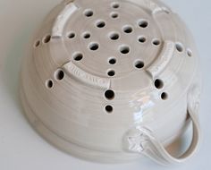 a white ceramic object with holes in it