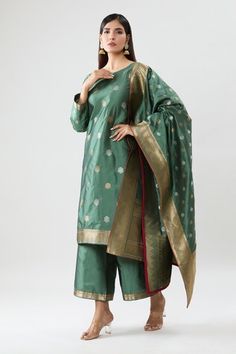 Green silk kurta with floral pattern. Comes with pant and a dupatta. - Aza Fashions Sheer Dupatta Katan Silk Sharara, Eid Sheer Dupatta Set In Katan Silk, Eid Katan Silk Sets With Sheer Dupatta, Katan Silk Sets With Straight Kurta And Dupatta, Anarkali Palazzo Set With Zari Weaving, Festive Palazzo Set With Zari Weaving For Festivals, Bollywood Style Pista Green Sets With Zari Weaving, Pista Green Bollywood Sets With Zari Weaving, Bollywood Pista Green Sets With Zari Weaving