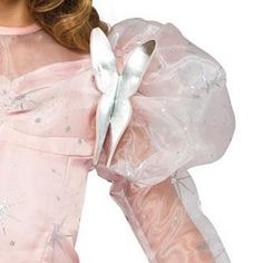 Get ready for a night you won't forget as your child shines bright in the Wizard of Oz: Glinda the Good Witch Deluxe Toddler Costume. Glinda was the character who sent Dorothy on the right path to get home and gave her as much advice as possible. Her charming personality and vibrant outfit is how everyone remembers Glinda. Your toddler will look just as amazing in this outfit which includes a pink poofy dress with silver decorations and a tall matching crown studded with silver beads and stars.… Pink Poofy Dress, Wizard Of Oz Color, Wizard Of Oz Glinda, Oz Costume, Silver Decorations, Toddler Costumes Girl, Charming Personality, Poofy Dress, Glinda The Good