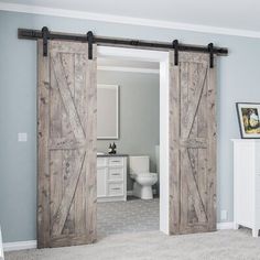 an open door leading to a bathroom with gray walls and carpeted flooring in the room