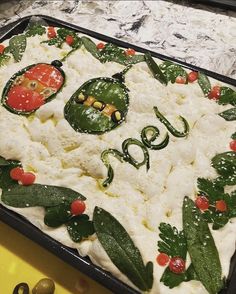 a dish with vegetables on it sitting on a counter