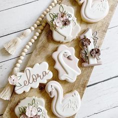 some decorated cookies are on a wooden board