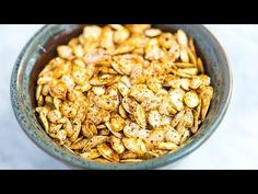 a bowl filled with granola sitting on top of a table