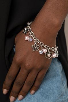 Infused with pink pearls and iridescent crystal-like beads, mismatched silver charms including a clover, butterfly, heart, and floral frames swing from a chunky silver chain around the wrist. Features an adjustable clasp closure. Pink Giraffe, Floral Frames, Butterfly Heart, Pink Pearls, Iridescent Crystal, Purple Pearl, Pink Box, Pearl Cluster, Paparazzi Accessories