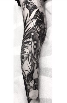 black and white photo of a woman's leg with flowers on it, done by the artist