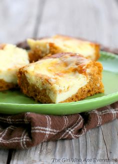 three pieces of cheesecake on a green plate with a brown and white checkered napkin