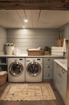 a washer and dryer in a room with wood flooring on the walls