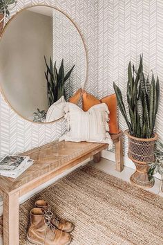 a wooden bench sitting in front of a mirror on top of a wall next to potted plants