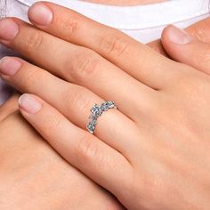 a woman's hand with a diamond ring on it