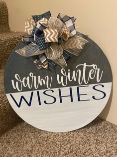 a sign that says warm winter wishes on the side of a set of carpeted stairs