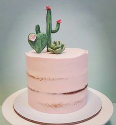 a pink cake with a cactus on top