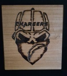 a wooden plaque with an image of a football helmet on it's face and the word sharper written in black ink